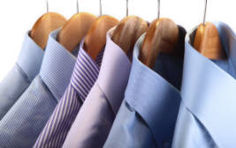 Cropped photo of shirts on hangers.